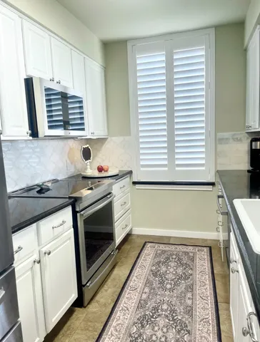 a kitchen with granite countertop a stove and a sink