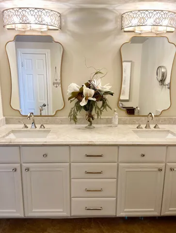a bathroom with a double vanity sink and a mirror