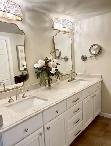 a bathroom with a sink a mirror and vanity