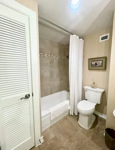 a view of a table and chairs under an umbrella