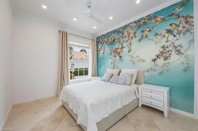 a large bed sitting in a bedroom next to a window