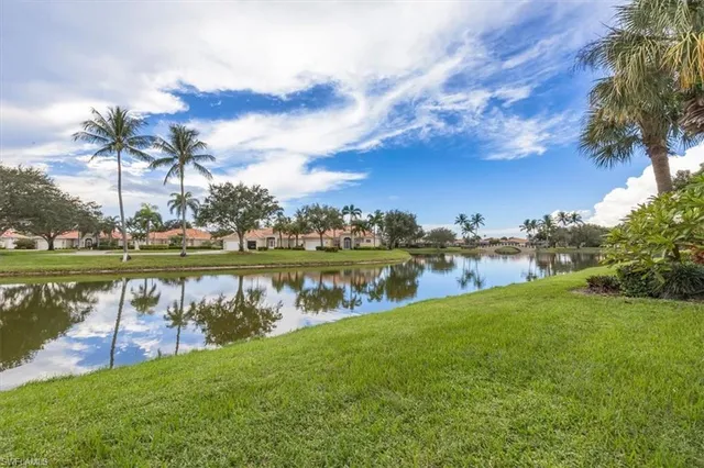 a front view of a house with a garden and a yard