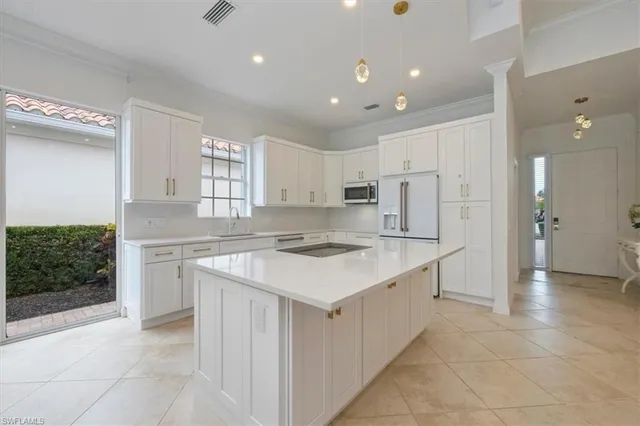 a kitchen with a stove a sink and a refrigerator