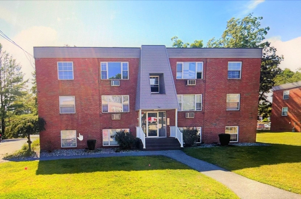 a front view of a building with garden