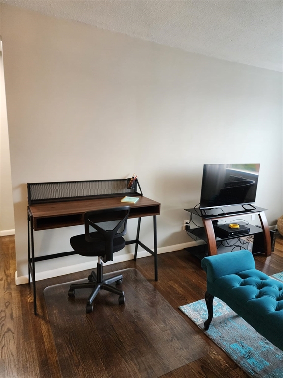99 Cluff Crossing Road, Unit B12 Salem, NH 03079 - Photo 4 of 12 a living room with furniture and a flat screen tv