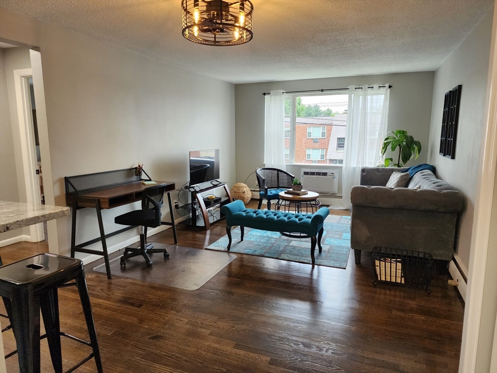99 Cluff Crossing Road, Unit B12 Salem, NH 03079 - Photo 6 of 12 a living room with furniture rug and a window
