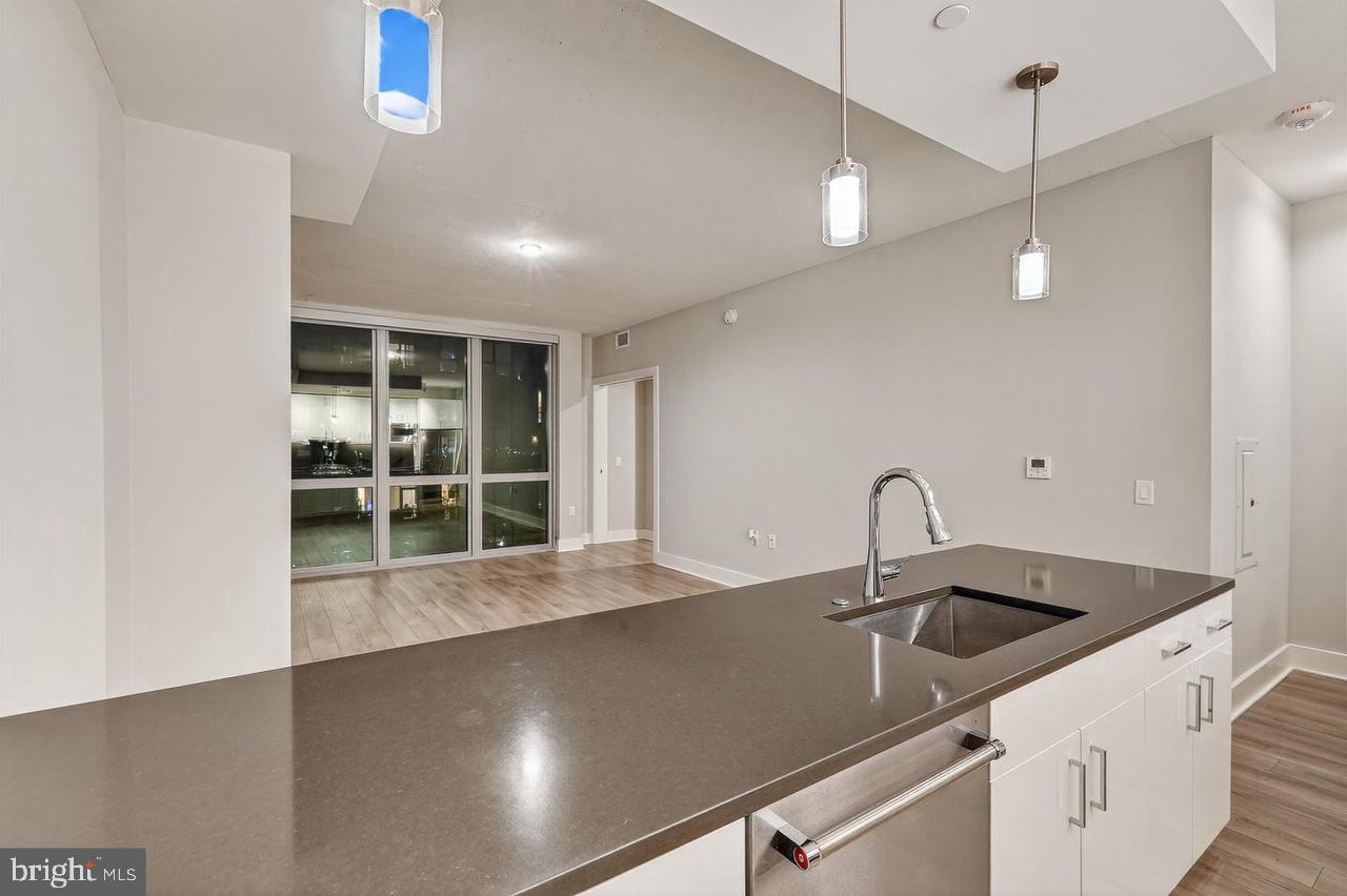 88 V Street Southwest, Unit 509 Washington, DC 20024 - Photo 7 of 35 a kitchen with a sink and chandelier