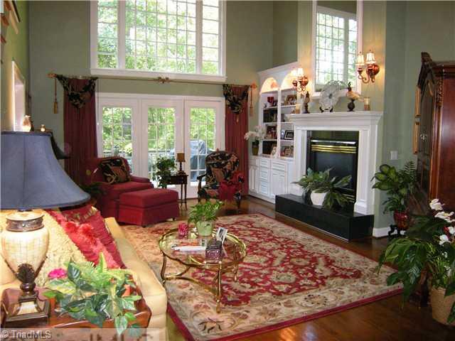 1812 Wild Fern Drive Oak Ridge, NC 27310 - Photo 2 of 14 Living Room. Looking towards the rear yard, the view is spectacular. The two story bank of windows overlook an area large enough for play that is bound by woods with a slight slope down to the Preservation Area along Stream Bed.