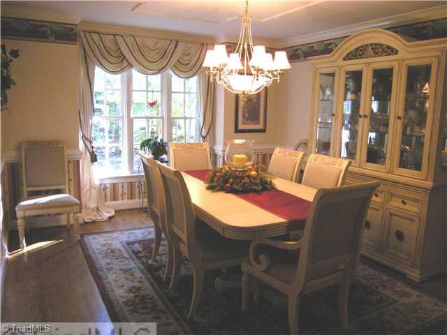 1812 Wild Fern Drive Oak Ridge, NC 27310 - Photo 7 of 14 Dining Room. The dining room is in the front of the house with good light. Hardwood flooring, chair and crown molding and well situated near the kitchen.