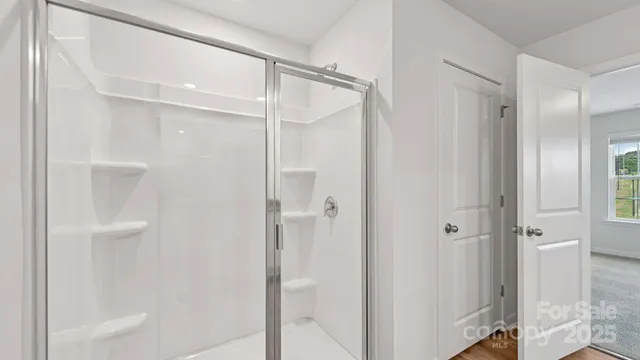 a bathroom with a glass shower door