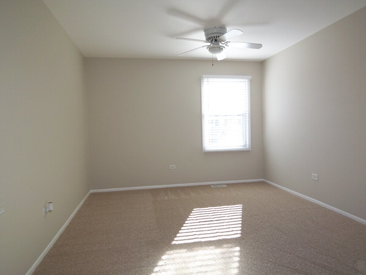 249 Nantucket Harbor Schaumburg, IL 60193 - Photo 21 of 26 an empty room with windows and fan