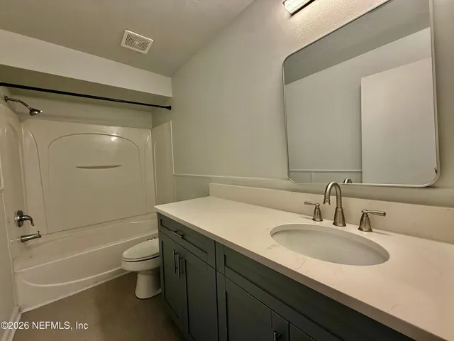 a bathroom with a sink toilet tub and shower