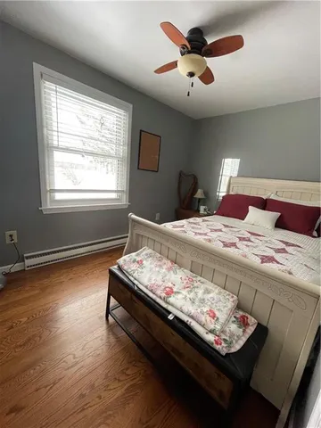 a bed sitting in a bedroom next to a window