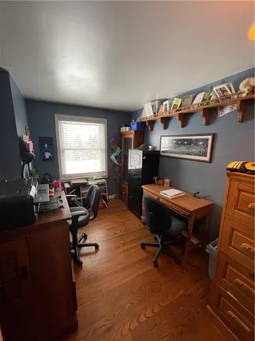a living room with furniture a piano and a flat screen tv