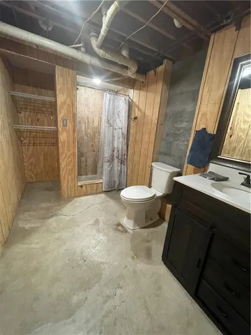 a view of an empty room with a fireplace and a window