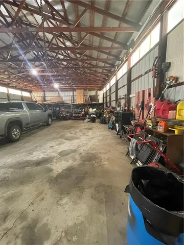 a view of a garage with a bike and wooden roof