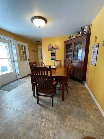 a view of a dining room with furniture and chandelier