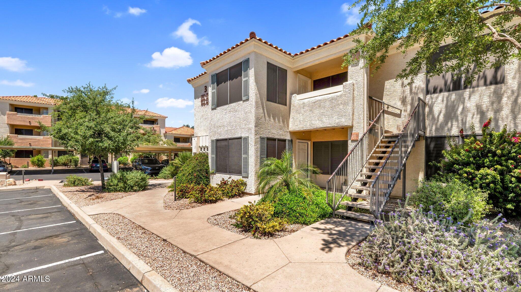 9990 North Scottsdale Road, Unit 1019 Paradise Valley, AZ 85253 - Photo 2 of 30 a front view of a house with a yard
