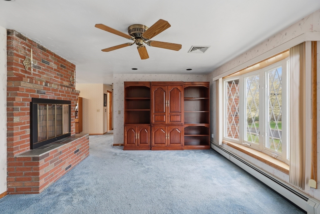 10 Deluca Road Milford, MA 01757 - Photo 7 of 37 a living room with furniture and a fireplace