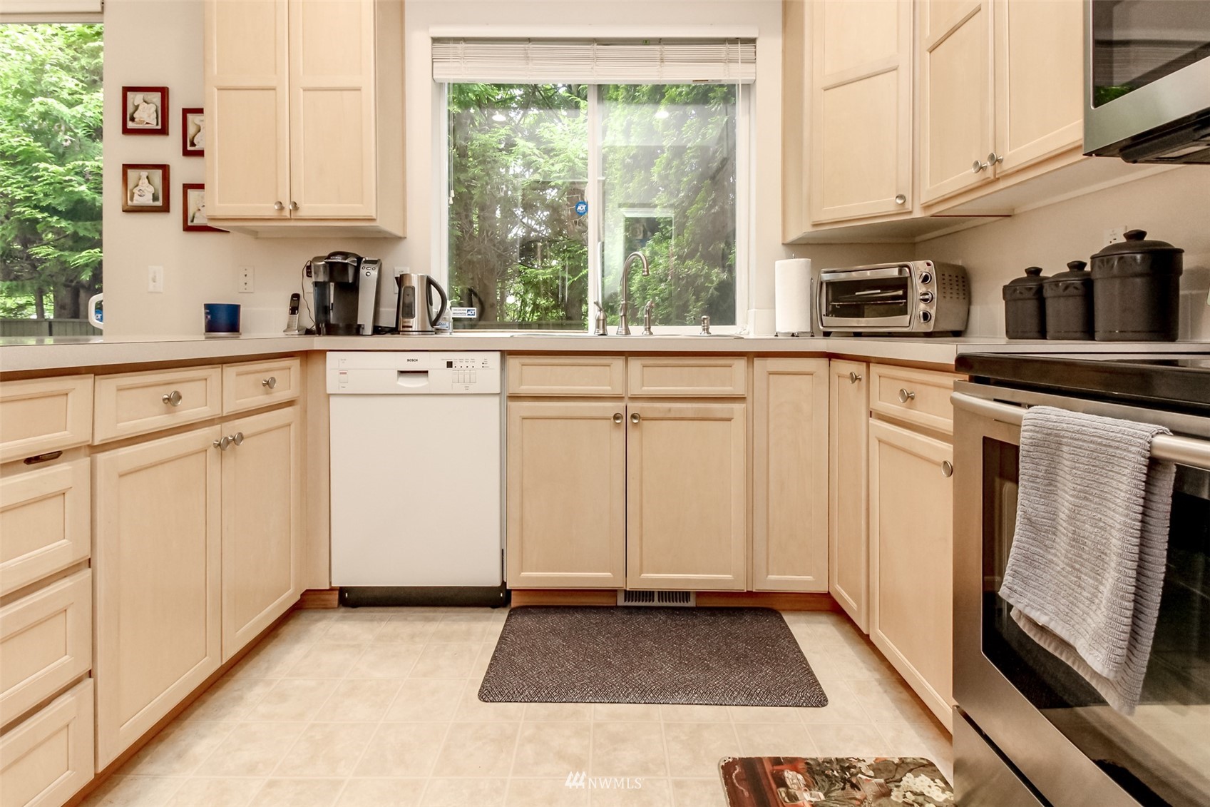 4632 Northeast 5th Court Renton, WA 98059 - Photo 11 of 23 a kitchen with white cabinets and sink