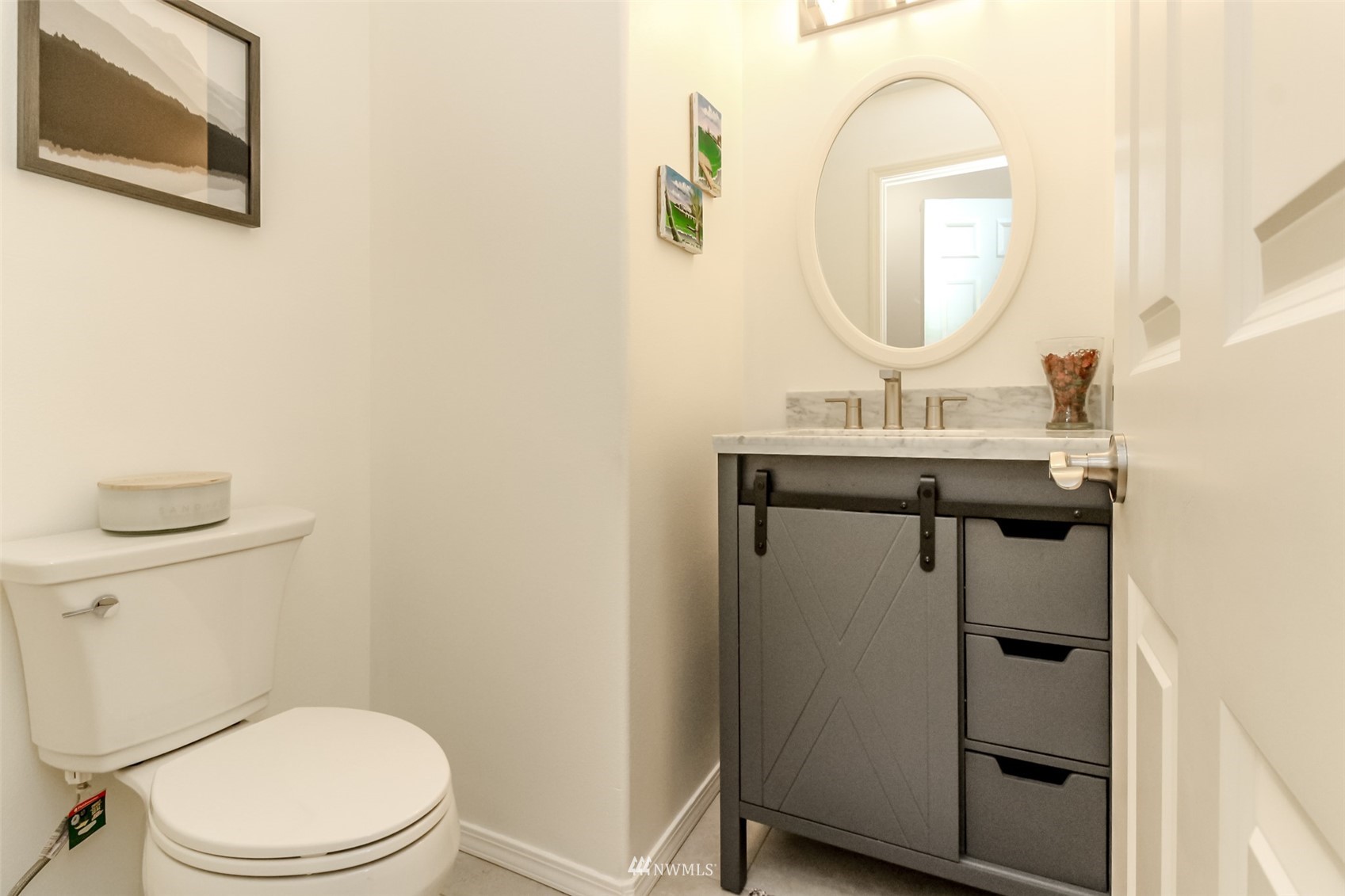 4632 Northeast 5th Court Renton, WA 98059 - Photo 12 of 23 a bathroom with a toilet a sink a mirror and a window