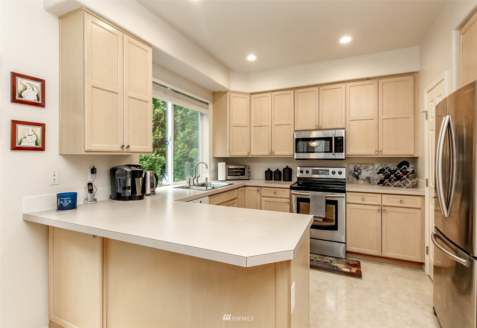 4632 Northeast 5th Court Renton, WA 98059 - Photo 9 of 23 a kitchen with a sink a window and stainless steel appliances