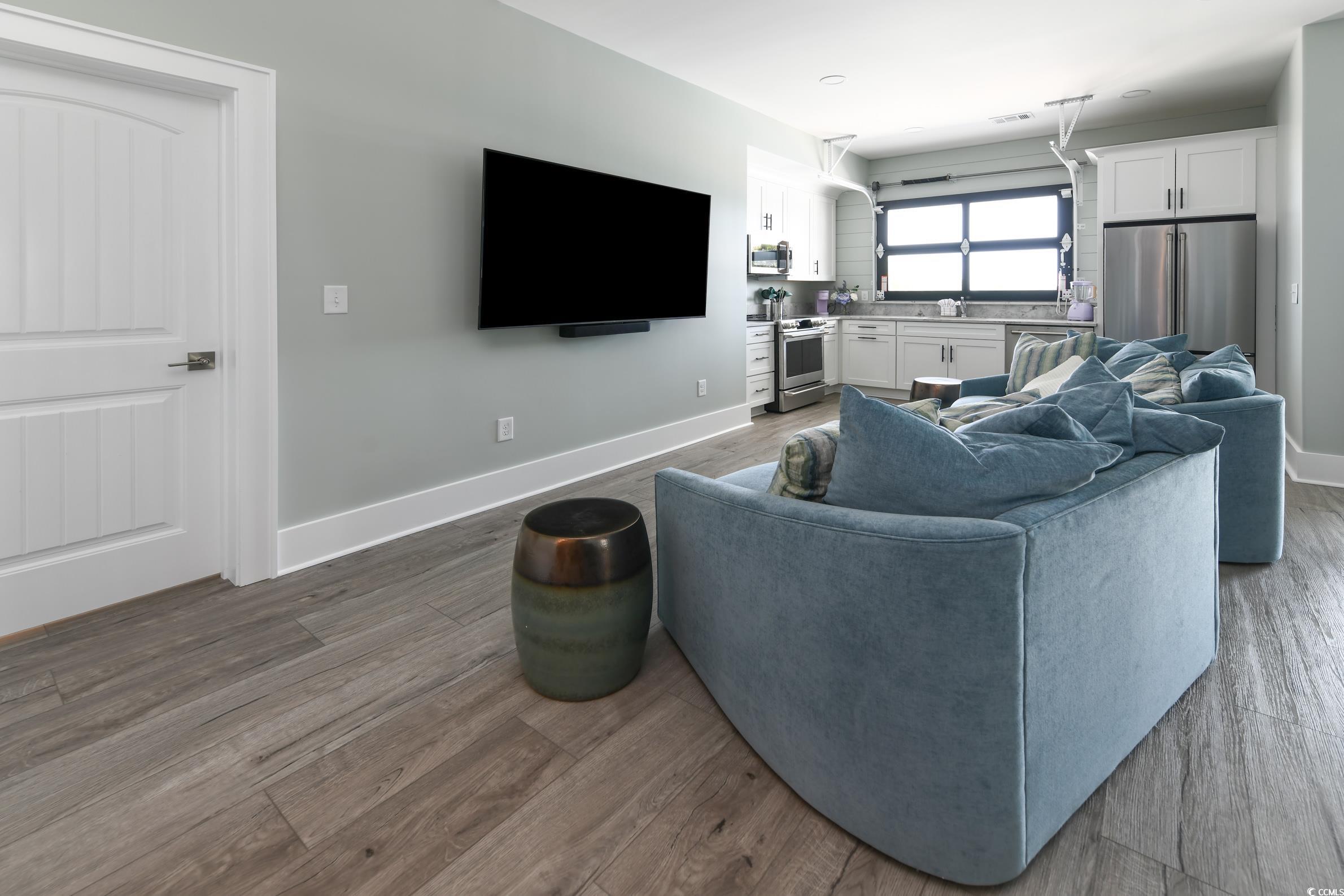 2349 South Waccamaw Drive Murrells Inlet, SC 29576 - Photo 14 of 39 Living room with baseboards and dark wood-style flooring
