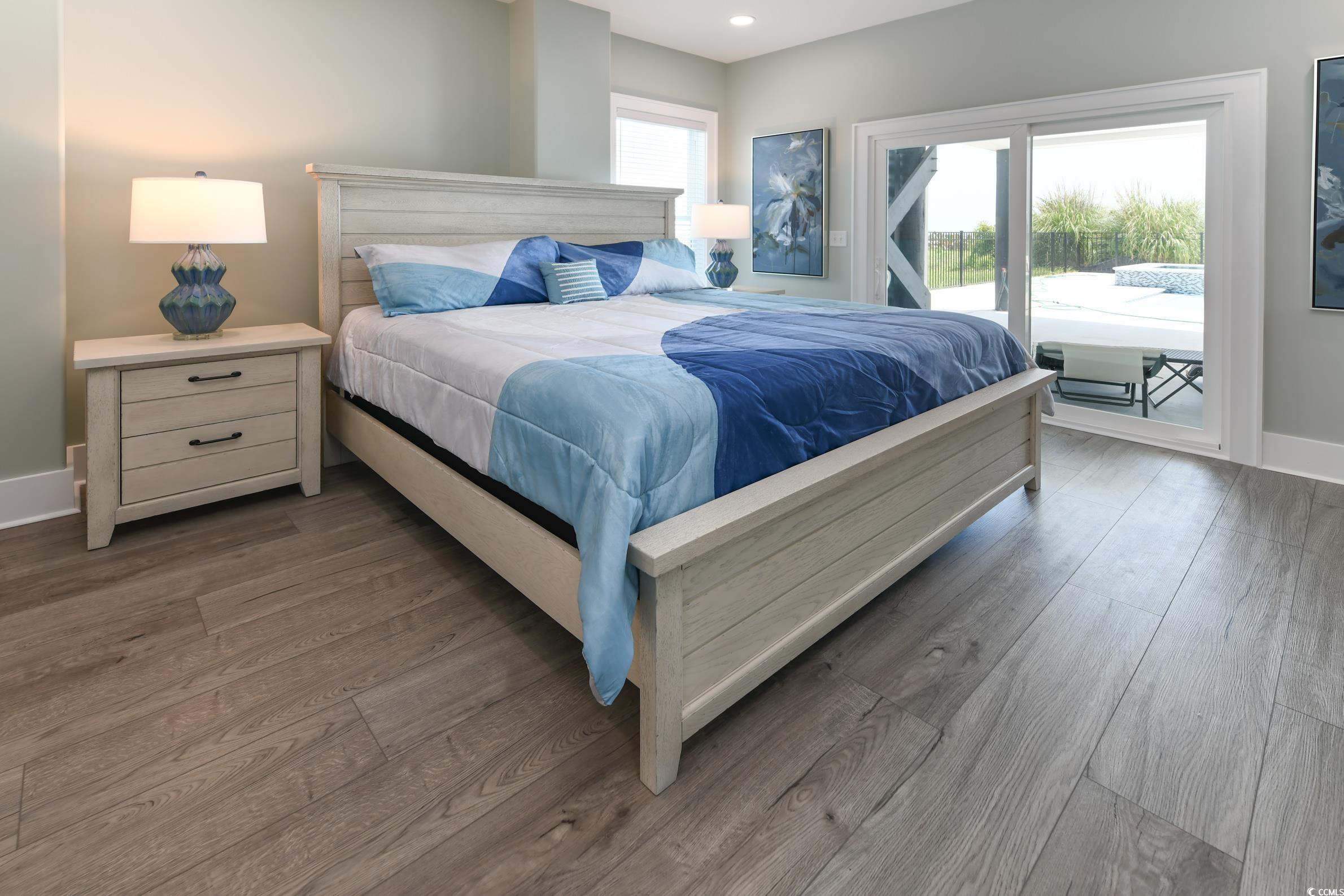 2349 South Waccamaw Drive Murrells Inlet, SC 29576 - Photo 15 of 39 Bedroom featuring baseboards, access to outside, recessed lighting, and wood finished floors
