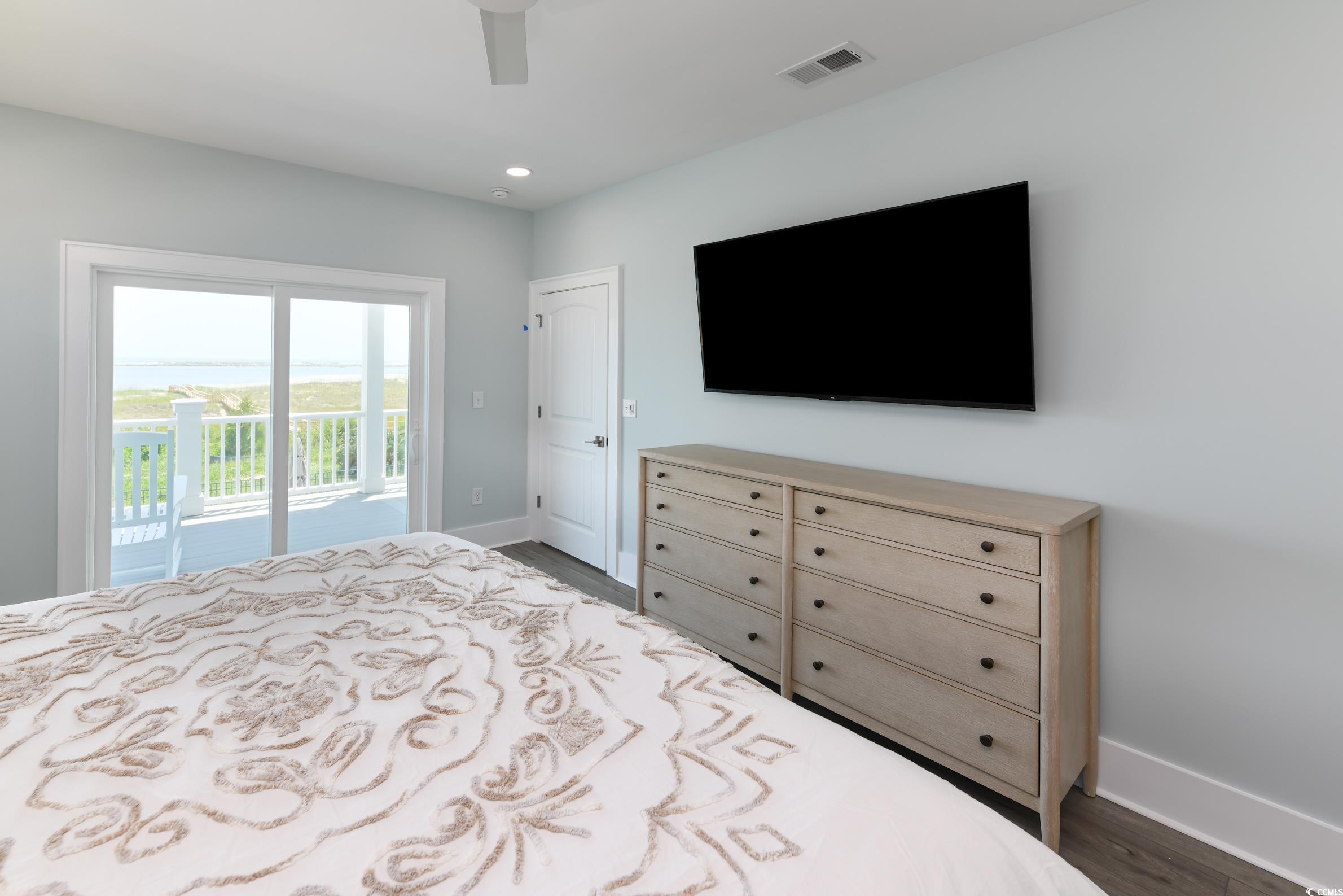 2349 South Waccamaw Drive Murrells Inlet, SC 29576 - Photo 16 of 39 Bedroom featuring dark wood finished floors, baseboards, access to outside, and visible vents