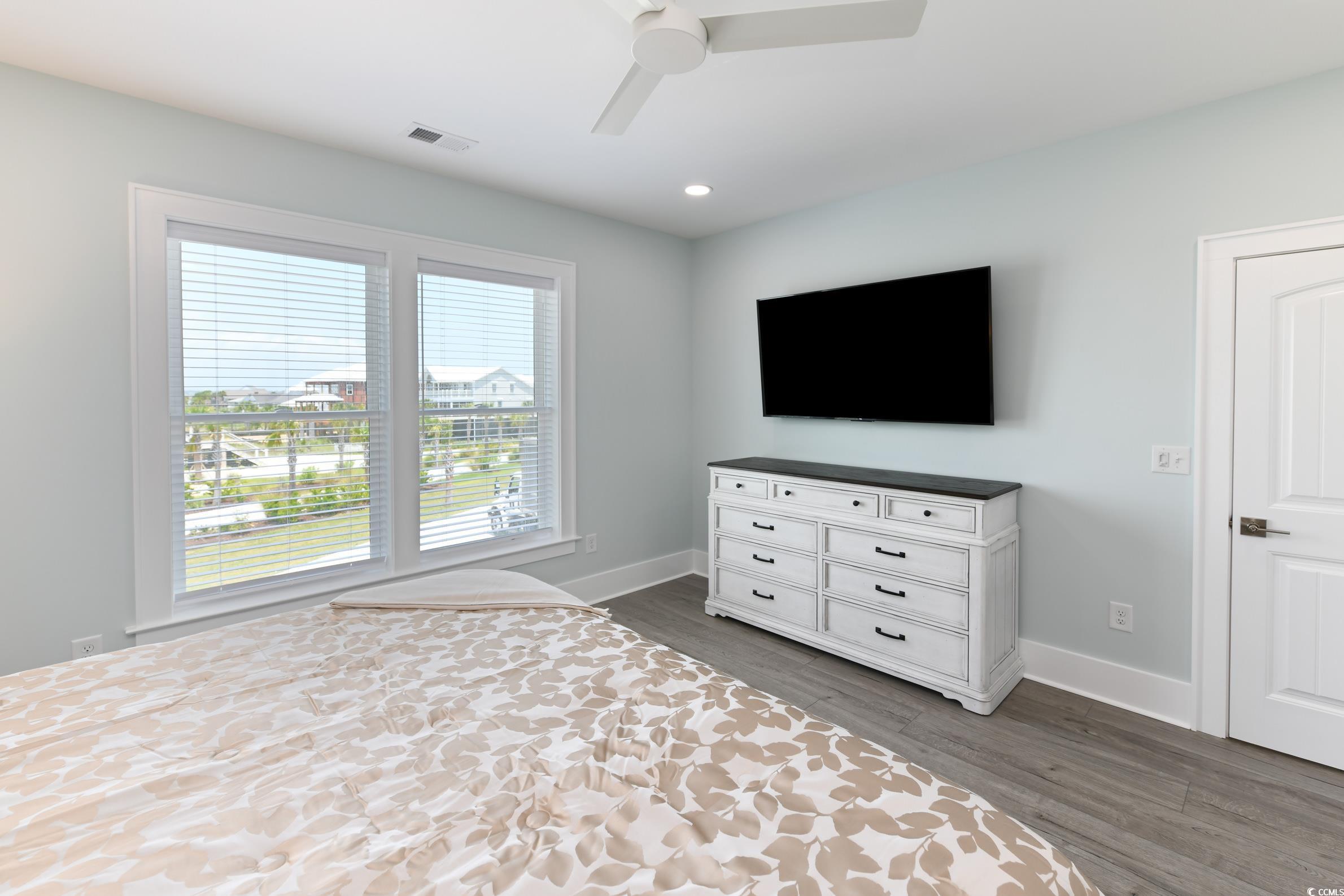 2349 South Waccamaw Drive Murrells Inlet, SC 29576 - Photo 17 of 39 Unfurnished bedroom featuring baseboards, dark wood-style flooring, ceiling fan, and visible vents