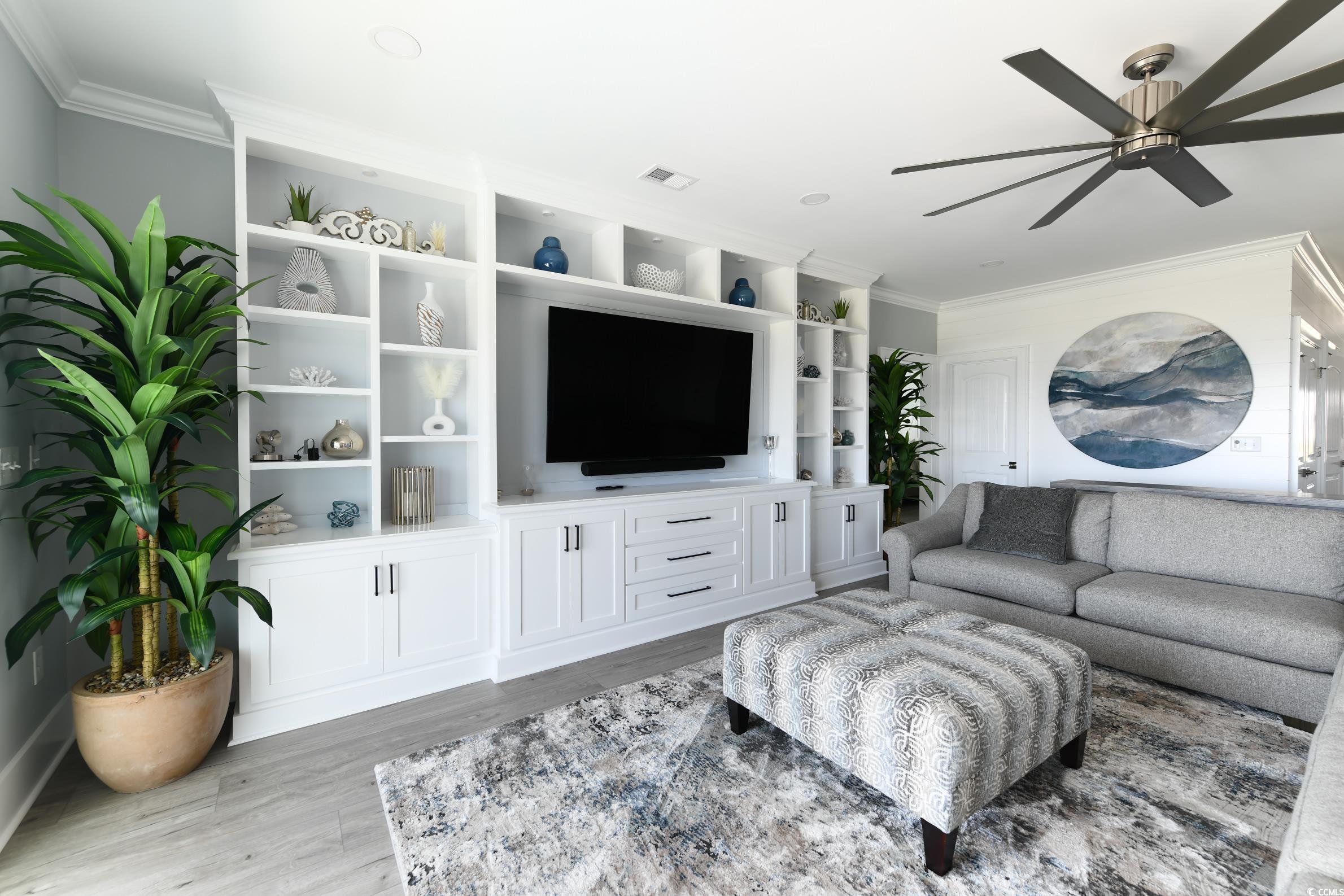 2349 South Waccamaw Drive Murrells Inlet, SC 29576 - Photo 20 of 39 Living area featuring visible vents, crown molding, light wood-style floors, and a ceiling fan