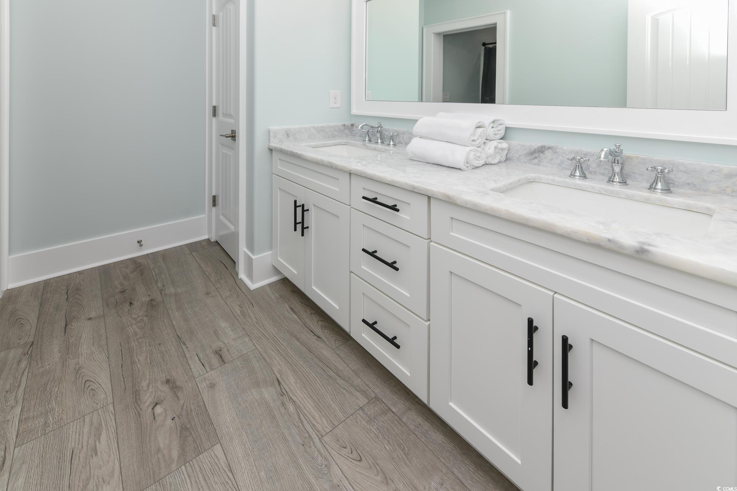 2349 South Waccamaw Drive Murrells Inlet, SC 29576 - Photo 23 of 39 Bathroom with baseboards, double vanity, a sink, and wood finished floors