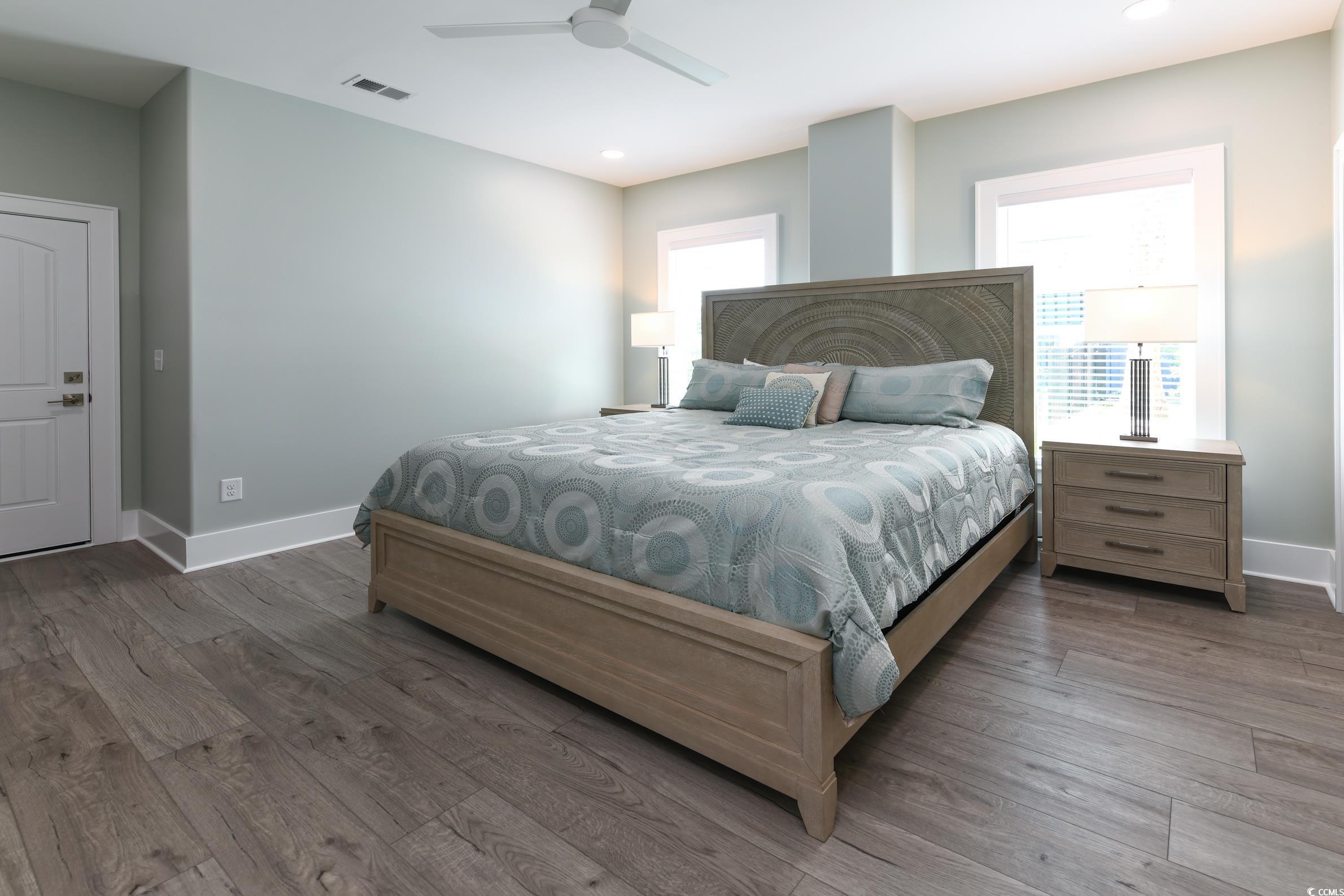 2349 South Waccamaw Drive Murrells Inlet, SC 29576 - Photo 29 of 39 Bedroom featuring baseboards, visible vents, a ceiling fan, and wood finished floors