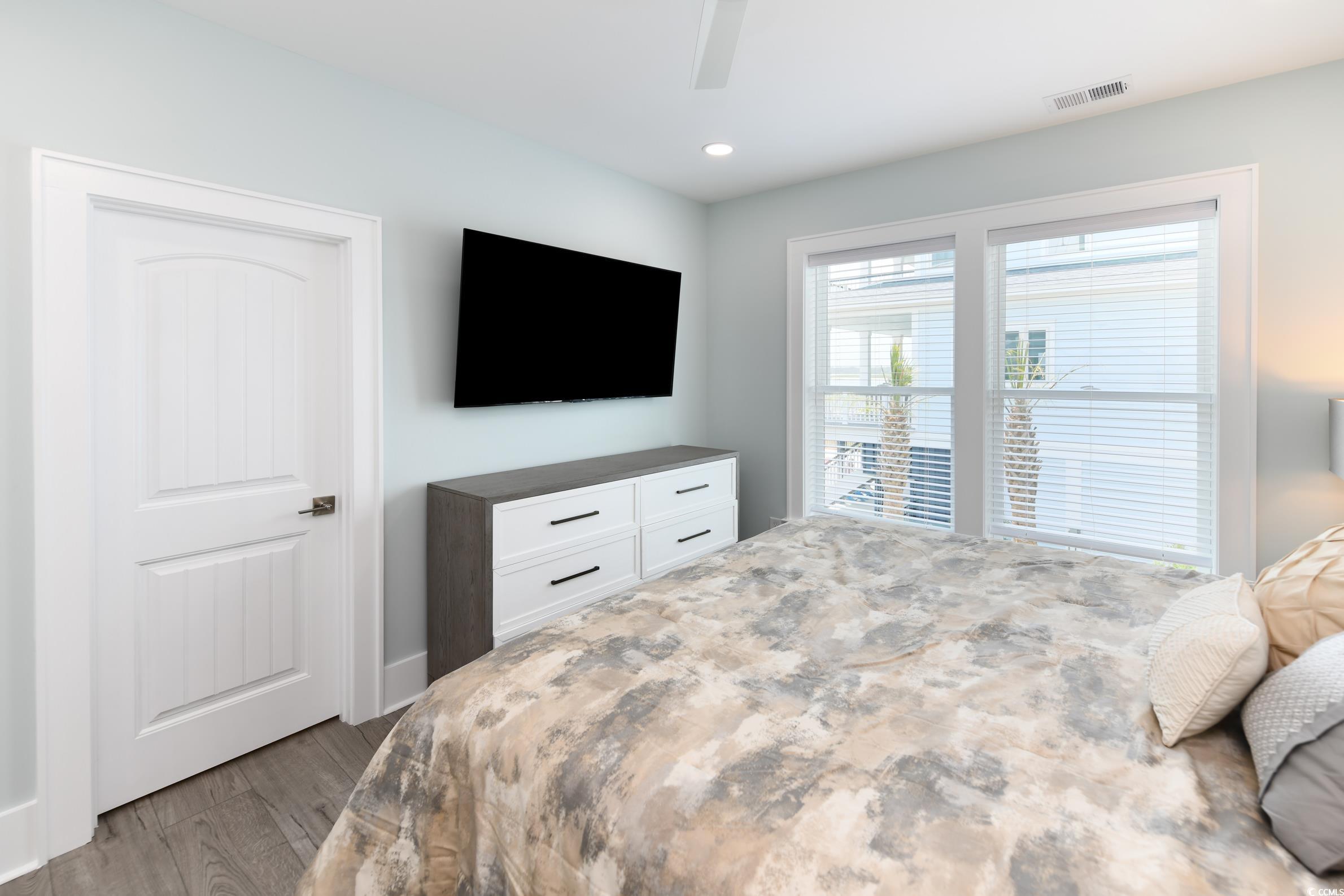 2349 South Waccamaw Drive Murrells Inlet, SC 29576 - Photo 30 of 39 Bedroom featuring visible vents, wood finished floors, recessed lighting, and a ceiling fan