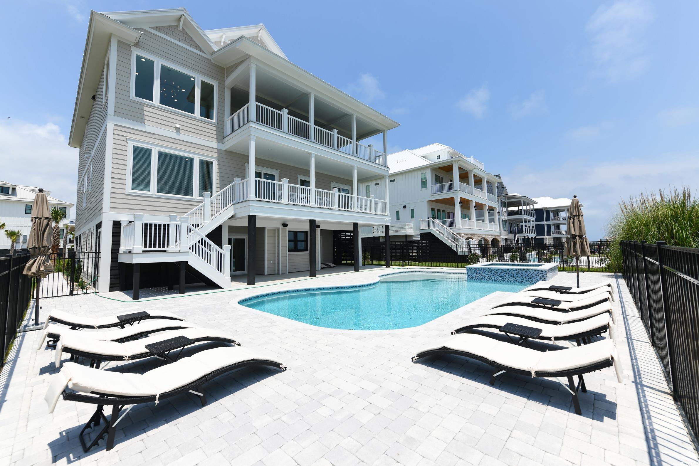 2349 South Waccamaw Drive Murrells Inlet, SC 29576 - Photo 34 of 39 View of pool featuring a patio area, stairs, a pool with connected hot tub, and fence