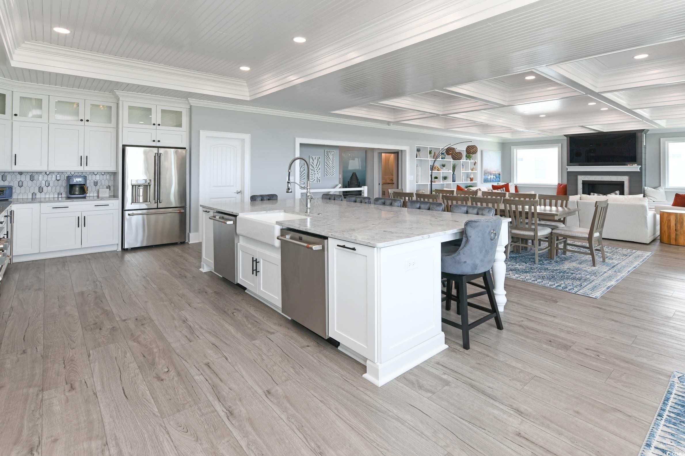 2349 South Waccamaw Drive Murrells Inlet, SC 29576 - Photo 39 of 39 Kitchen with a sink, a kitchen bar, appliances with stainless steel finishes, open floor plan, and ornamental molding