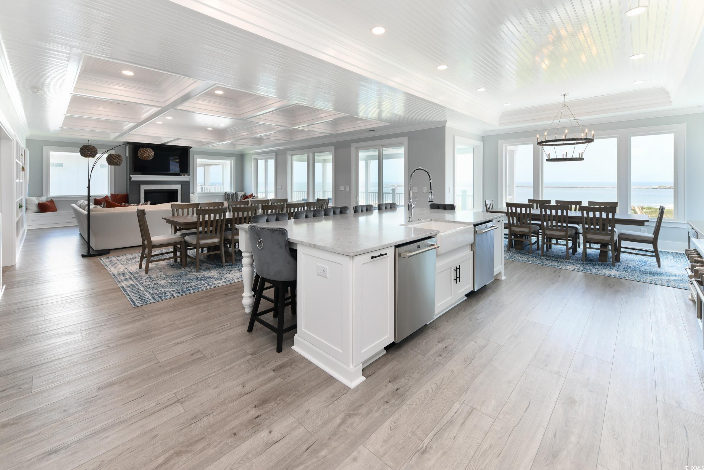 2349 South Waccamaw Drive Murrells Inlet, SC 29576 - Photo 5 of 39 Kitchen with dishwasher, a breakfast bar, a fireplace, white cabinetry, and a sink