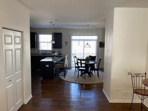 2847 Henley Lane Naperville, IL 60540 - Photo 2 of 9 a view of dining room and livingroom with furniture wooden floor windows and a view