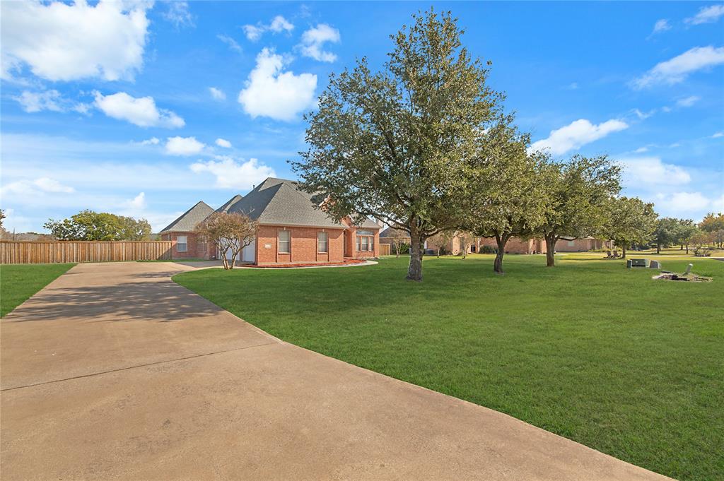 9467 Blarney Stone Way Forney, TX 75126 - Photo 1 of 1 View of front facade featuring concrete driveway, brick siding, and roof with shingles