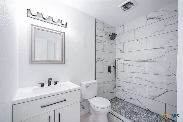 a bathroom with a sink toilet and shower