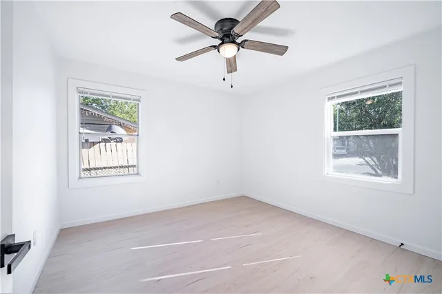 a view of an empty room with a window