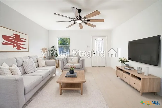 a living room with furniture and a flat screen tv