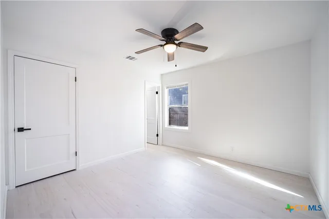 a view of an empty room with a window