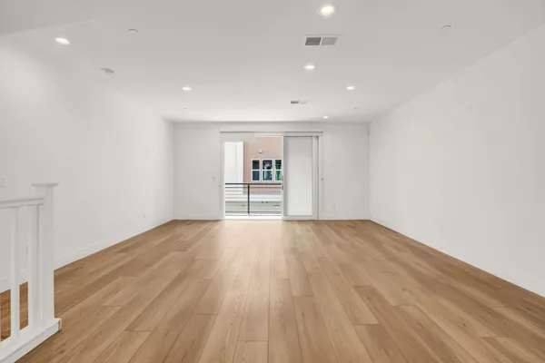 a large kitchen with a center island and stainless steel appliances