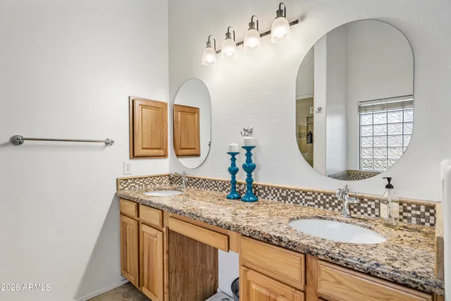 a bathroom with a granite countertop bathtub and a shower