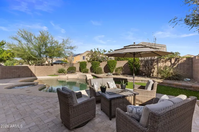 a view of a house with backyard and sitting area