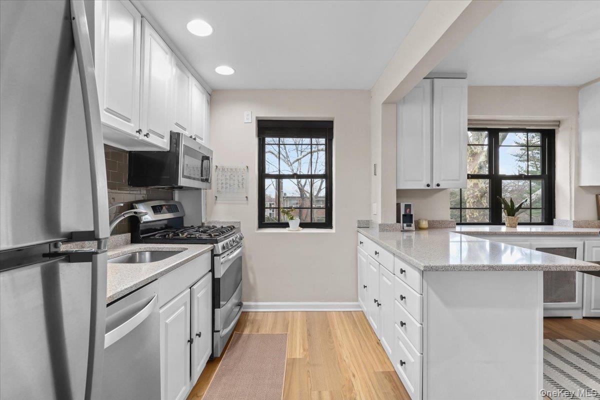 33 Manchester Road, Unit 2R Eastchester, NY 10709 - Photo 5 of 20 a kitchen with a sink stove top oven and refrigerator