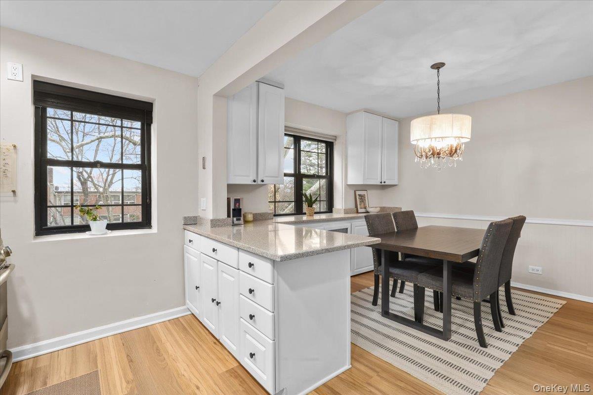 33 Manchester Road, Unit 2R Eastchester, NY 10709 - Photo 8 of 20 a view of a dining room with furniture window and wooden floor