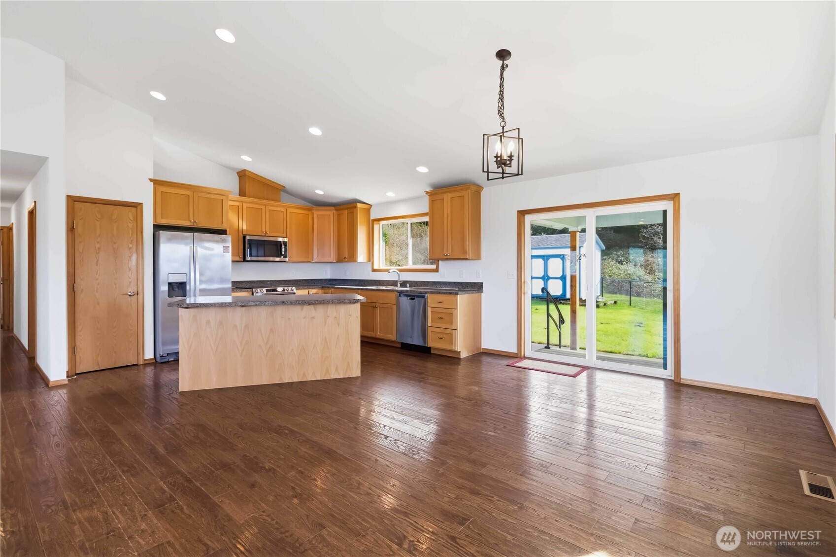 58 Alger Creek Heights Road Cathlamet, WA 98612 - Photo 14 of 40 a view of kitchen with stainless steel appliances granite countertop a refrigerator a stove top oven a sink and a wooden floor