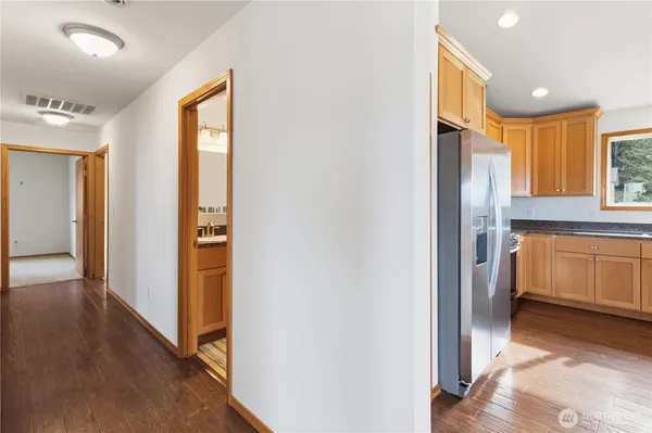 a view of a kitchen with a refrigerator and a sink